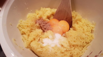 Kartoffelmehl, Muskatnuss, Eigelb und Salz zur Kartoffelmasse geben